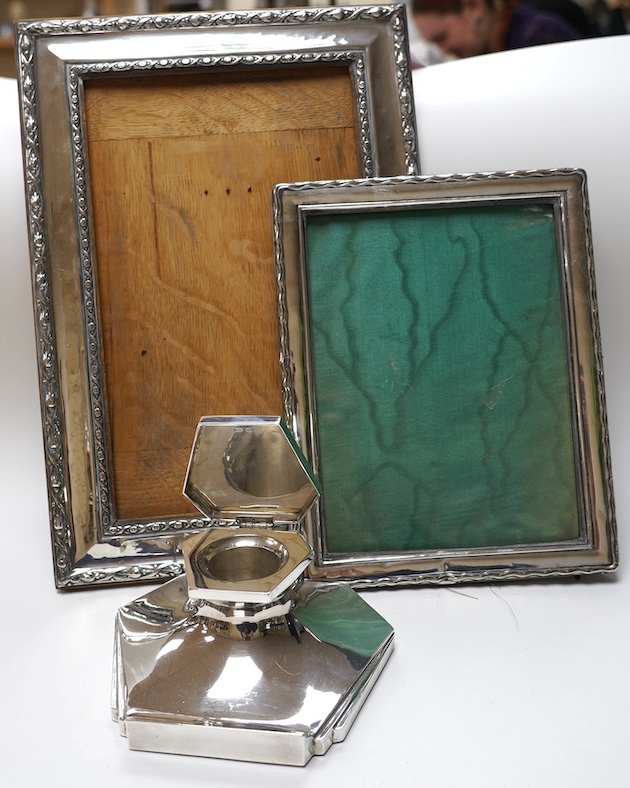 A George VI Art Deco silver mounted inkwell, Sheffield, 1949, 15.1cm and two early 20th century silver mounted rectangular photograph frames, largest 34.2cm. Condition - poor to fair